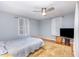 Comfortable bedroom featuring hardwood floors, ceiling fan, and two bright windows at 206 N State St, Raleigh, NC 27601