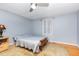 Cozy bedroom featuring hardwood floors, ceiling fan, a window and natural light at 206 N State St, Raleigh, NC 27601