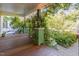 Covered porch with plants climbing up support beams and an iron railing at 206 N State St, Raleigh, NC 27601