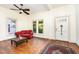 Bright living room with hardwood floors, a comfortable red couch, and windows that provide ample natural light at 206 N State St, Raleigh, NC 27601