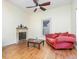Cozy living room with fireplace, wood floors, ceiling fan and a red sofa at 206 N State St, Raleigh, NC 27601