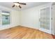 Bright living room featuring hardwood floors, ceiling fan, and backyard door with window at 206 N State St, Raleigh, NC 27601