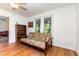 Comfortable sitting area featuring a futon, bookshelf, hardwood floors, and natural light from large windows at 206 N State St, Raleigh, NC 27601