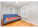 This spare room features hardwood flooring, 2 bright windows and a futon bed at 206 N State St, Raleigh, NC 27601