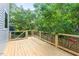 New back deck overlooking lush, green trees and foliage at 2205 Tampa Ave, Durham, NC 27705