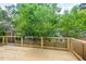 Wooden back deck overlooking lush green trees in a private backyard setting at 2205 Tampa Ave, Durham, NC 27705
