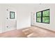 Bright bedroom with wood floors and a large window with backyard views at 2205 Tampa Ave, Durham, NC 27705