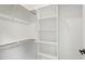 Walk-in closet features built-in shelving and hanging rods at 2205 Tampa Ave, Durham, NC 27705