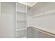 Walk-in closet features built-in shelving and hanging rods at 2205 Tampa Ave, Durham, NC 27705