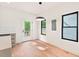 Bright dining area with hardwood floors, modern lighting, and access to a wooden deck at 2205 Tampa Ave, Durham, NC 27705
