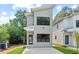 Contemporary two-story home with a gray exterior, modern design elements, and green lawn at 2205 Tampa Ave, Durham, NC 27705