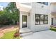 Home front entry featuring a modern, sleek design with a glass-paneled door and well-maintained landscaping at 2205 Tampa Ave, Durham, NC 27705
