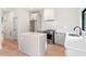 Bright and modern kitchen featuring an island, stainless steel appliances, and white subway tile backsplash at 2205 Tampa Ave, Durham, NC 27705