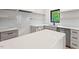 Modern kitchen featuring light gray cabinets, white countertops, subway tile backsplash, and stainless-steel appliances at 2205 Tampa Ave, Durham, NC 27705