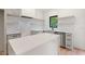 Modern kitchen featuring light gray cabinets, white countertops, subway tile backsplash, and stainless-steel appliances at 2205 Tampa Ave, Durham, NC 27705