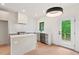 New kitchen with stainless appliances, island, and door to deck at 2205 Tampa Ave, Durham, NC 27705
