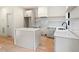 Well-lit kitchen featuring a modern island and bright countertops with an abundance of cabinet space at 2205 Tampa Ave, Durham, NC 27705