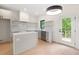 Bright kitchen with white cabinets, stainless steel appliances, and a door to the outside deck at 2205 Tampa Ave, Durham, NC 27705