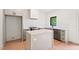 Modern kitchen with gray cabinets, stainless steel appliances, white countertops, and an island at 2205 Tampa Ave, Durham, NC 27705