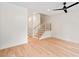Bright living area featuring hardwood floors, white walls, modern staircase, and neutral decor at 2205 Tampa Ave, Durham, NC 27705