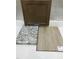 Sample board displaying cabinet door, white countertop with light stone counter, and wood-look floor at 260 Meadowbark Bnd # 44, Garner, NC 27529
