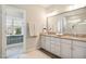 Bathroom vanity featuring double sinks, granite counters, and a large mirror at 2601 Brookstone Ridge, Raleigh, NC 27613