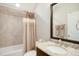 Well-lit bathroom features a granite countertop, dark wood vanity, and tiled shower/tub combination at 2601 Brookstone Ridge, Raleigh, NC 27613