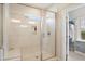 Tiled shower with a glass door, a built-in seat, and a view into the walk-in closet at 2601 Brookstone Ridge, Raleigh, NC 27613