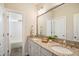 Bathroom with a double sink vanity with granite countertops and a walk-in shower with white subway tile at 2601 Brookstone Ridge, Raleigh, NC 27613