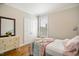 Cozy bedroom with hardwood floors, a comfortable bed, and a dresser create a peaceful retreat at 2601 Brookstone Ridge, Raleigh, NC 27613