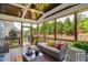 Inviting screened-in porch featuring an outdoor ceiling fan, comfortable seating, and an entrance leading to the yard at 2601 Brookstone Ridge, Raleigh, NC 27613