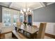 Bright dining room with large windows, a modern table, and elegant lighting at 2601 Brookstone Ridge, Raleigh, NC 27613