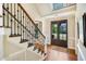 Grand foyer with staircase, hardwood floors, and a stylish double door entrance at 2601 Brookstone Ridge, Raleigh, NC 27613
