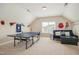 Fun game room with ping pong table, seating, and sports decor for entertainment and relaxation at 2601 Brookstone Ridge, Raleigh, NC 27613