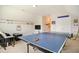 Fun game room with ping pong table, seating, and sports decor for entertainment and relaxation at 2601 Brookstone Ridge, Raleigh, NC 27613