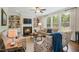 Cozy living room with a fireplace, built-in bookshelves, and large windows at 2601 Brookstone Ridge, Raleigh, NC 27613