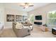 Spacious living room with a large sectional sofa, mounted TV, and natural light at 2601 Brookstone Ridge, Raleigh, NC 27613