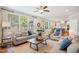 Bright, open living room with neutral furniture, lots of windows, and access to kitchen at 2601 Brookstone Ridge, Raleigh, NC 27613
