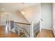 Elegant staircase with hardwood steps, iron railing, and a decorative chandelier offers a grand entrance at 2601 Brookstone Ridge, Raleigh, NC 27613