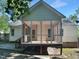 Home's rear exterior showcasing a large screened-in porch with ceiling fan at 2747 Michelle Ct, Creedmoor, NC 27522