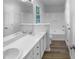 Bright bathroom features double sinks, large mirror, and combination tub/shower at 2747 Michelle Ct, Creedmoor, NC 27522