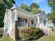 Charming home featuring a welcoming front porch, red shutters, and brick accents at 2747 Michelle Ct, Creedmoor, NC 27522
