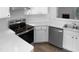 Modern kitchen featuring stainless steel appliances, white cabinetry, and sleek countertops at 2747 Michelle Ct, Creedmoor, NC 27522