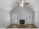Living room featuring a fireplace, ceiling fan, and vaulted ceiling at 2747 Michelle Ct, Creedmoor, NC 27522