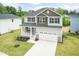 Aerial view of a two-story home with a landscaped yard and a two-car garage at 283 Hopewell Br Ct, Smithfield, NC 27577
