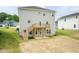 Backyard featuring a wood deck with stairs, gray vinyl siding, and landscaping at 283 Hopewell Br Ct, Smithfield, NC 27577