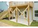 Detail of the backyard under the deck featuring a concrete patio and sturdy wooden support beams at 283 Hopewell Br Ct, Smithfield, NC 27577