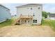 Backyard with a wooden deck, stairs to the ground, and vinyl siding on the house at 283 Hopewell Br Ct, Smithfield, NC 27577