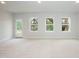 Spacious basement with carpet, natural light from the windows, and a door to the outside at 283 Hopewell Br Ct, Smithfield, NC 27577