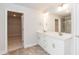 Bathroom featuring double sink vanity with a large mirror and tile floors at 283 Hopewell Br Ct, Smithfield, NC 27577